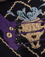 Close up of the left side sphynx face, skull, and ghouls.