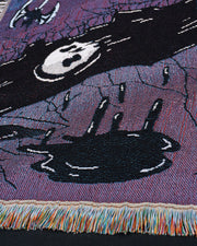 Close up of puddle dripping upwards, and skull in the black river.
