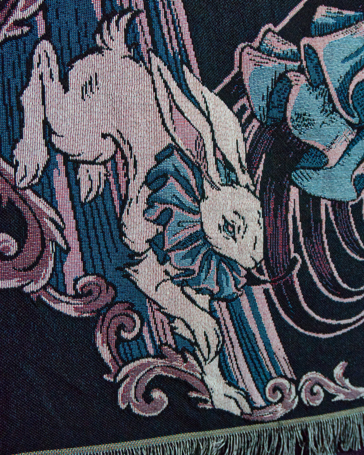 Close up of white rabbit with blue ruffled collar.