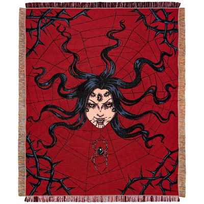 A spider queen's head with seven yellow eyes, and long black hair spreads out in the center of a web, with a spider crawling from her mouth