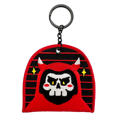 Red reaper with horns, making angry face. Red border and a star on either side.