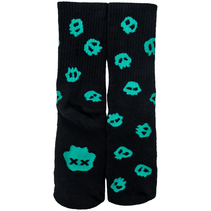 Black socks with green skull repeating pattern. Larger skull with X eyes on the bottom soles.