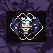 Four eyed sphynx cat head, split in the center with an exposed skull behind strings of skin. Blue ghouls escape within. Thorned frame design.
