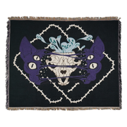 Purple four eyes sphynx cat head, split in the center, and it's skull sits behind strings of skin connecting the two halves. Blue ghouls escape the open skull. Black background with intertwining thorns frame design.