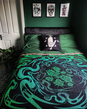Underworld resting on a green sheet bed with a mystic hand pillow against a green wall, surrounded by gothic room decor. SpookyLittleLair commission.